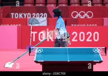 Tokyo, Japan. 19th July, 2021. A staff member cleans the floor at Tokyo Metropolitan Gymnasium in Tokyo, Japan, July 19, 2021. Credit: Wang Dongzhen/Xinhua/Alamy Live News Stock Photo