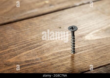 Premium Photo  Selftapping screws on the background of a wooden board  closeup