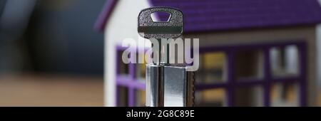 Keyhole and keys lying on background of toy wooden house Stock Photo