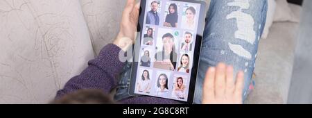 Man communicating with many colleagues on digital tablet at home Stock Photo