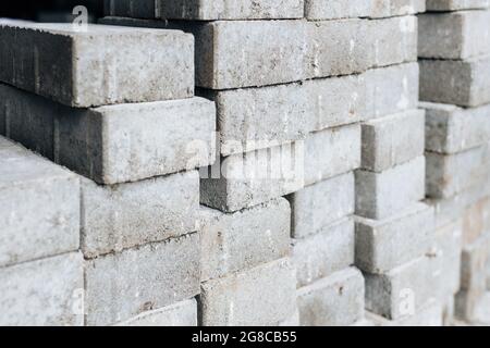 Gray silicate bricks are stacked. Industrial background. Concept of construction. Stock Photo