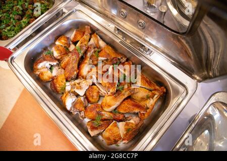 baked chicken drumsticks in a metal dish. Stock Photo