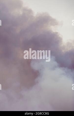 Swirling smoke from a large fire, similar to clouds. Cumulus clouds. Stock Photo