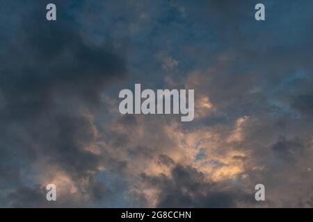 Dramatic grey, blue and apricot twilight sky. Stock Photo