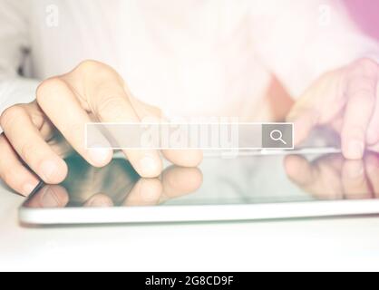 Close up of a business man while reseaching using a digital tablet. Stock Photo
