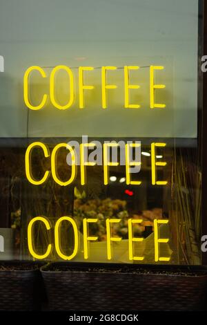 neon coffee sign cafe window showcase.concept cafe business . yellow color Stock Photo