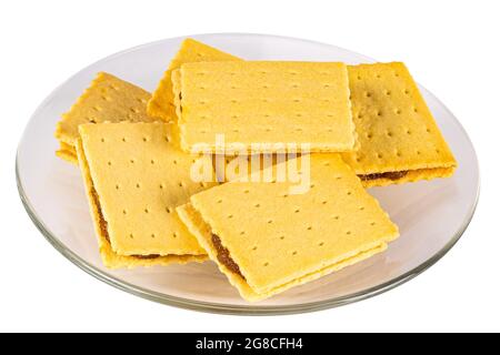 High angle view pile of homemade crispy pineapple cheese shake biscuit in transparent glass dish on white background with clipping path. Stock Photo