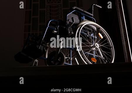 Wheelchair at the top of a flight of stairs Stock Photo