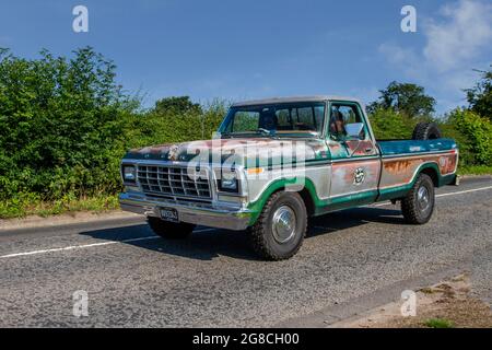 1977 70s rusty green American Ford 150 Truck, 4949cc pickup, en-route to Capesthorne Hall classic July car show, Cheshire, UK Stock Photo