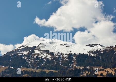 Paraglider and glider over snowy peaks of Vilan massif in Gruesch/Fanas region, Switzerland Stock Photo