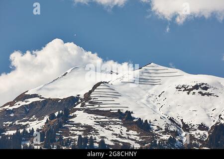Paraglider over snowy peaks of Vilan massif in Gruesch/Fanas region, Switzerland Stock Photo