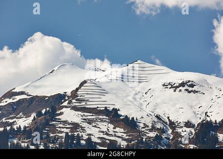 Paraglider over snowy peaks of Vilan massif in Gruesch/Fanas region, Switzerland Stock Photo