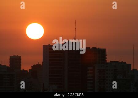 the buildings with the orange sun behind, backlight Stock Photo