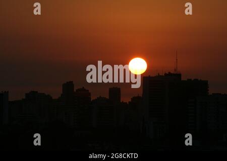 the buildings with the orange sun behind, backlight Stock Photo