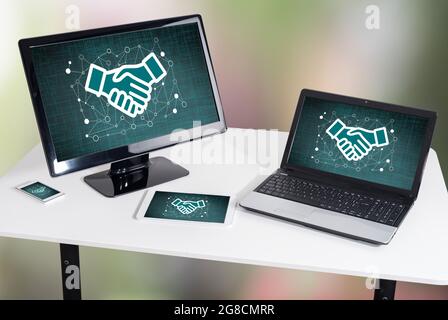 Business partnership concept shown on different information technology devices Stock Photo
