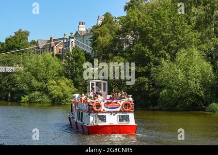 Chester, Cheshire, England - July 2021: Tourist boats taking visitors on a cruise on the River Dee, which flows through the city of Chester. Stock Photo