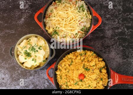 red iron pot with Farofa. Traditional Brazilian food. On a dark background. Stock Photo