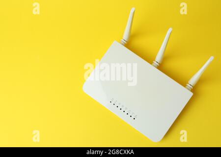 Wi-Fi router with external antennas on yellow background Stock Photo