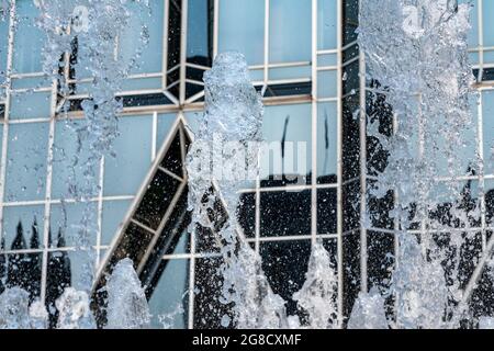 Frozen water from fountain in front of reflective office building in downtown Pittsburgh Stock Photo