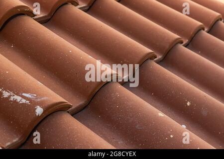 Red tile roof with white paint drops, closeup photo with selective focus Stock Photo