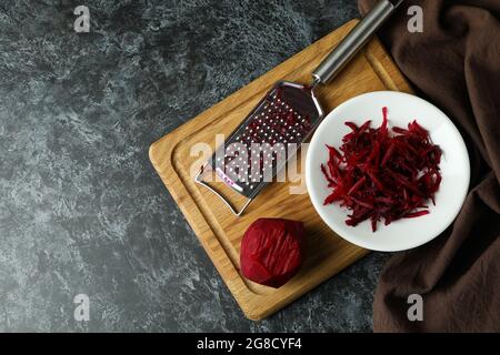 Fresh grated beets on black smokey table Stock Photo