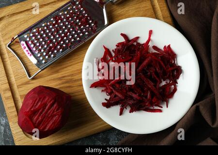 Fresh grated beets on black smokey table Stock Photo