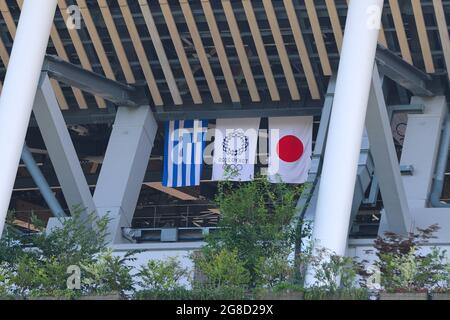 Tokyo, Japan. 19th July, 2021. Flags of Greece, the IOC and Japan at the National Stadium in Shinjuku. (Photo by Stanislav Kogiku/SOPA Images/Sipa USA) Credit: Sipa USA/Alamy Live News Stock Photo