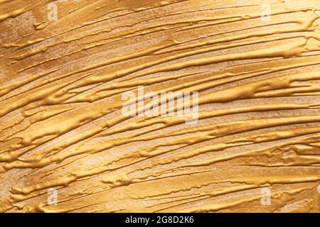 golden background, brush strokes with golden paint, beautiful volume yellow texture for holiday greetings or text, template. Stock Photo