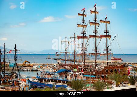 ALANYA, TURKEY - May17, 2014: People having fun in vintage pirate ships at the dock in Alanya, Turkey. Stock Photo