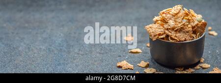 Dry muesli in a saucer on the background of a stone table top. Healthy food and light diet breakfast concept, copy space Stock Photo