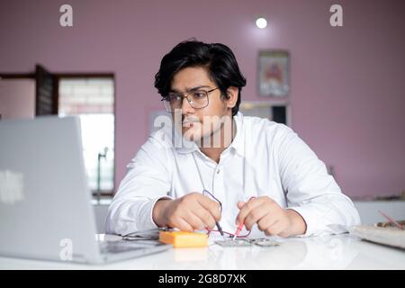 portrait of young Male student in Lab performing experiment in lab Stock Photo