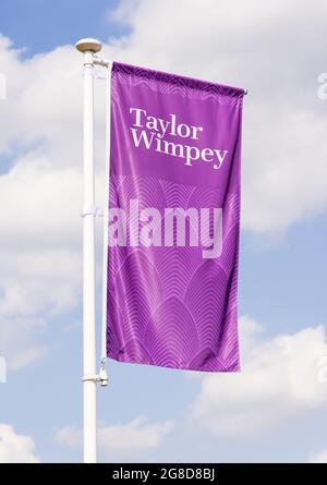 Taylor Wimpey advertising flag banner at a new housing development. UK Stock Photo