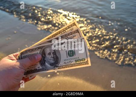 Three Hundred Dollar Bills On Background Of Sea Surface 100 Dollar Cash Stock Photo Alamy