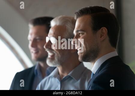 Happy young male business leader looking away and smiling Stock Photo
