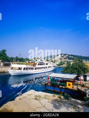 Cruise yacht entering the canal of Corinth, moored vintage car ferry, Isthmia, Peloponnese, Greece, Europe,