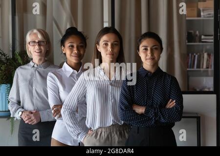Portrait of young Indian female business leader with diverse team Stock Photo