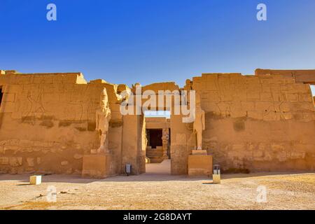 Views of the temple of Ramses III with Osiris pillars in the courtyard ...