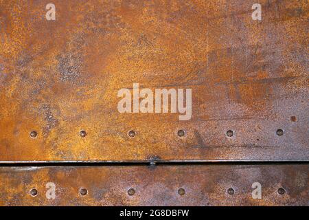 rusty iron texture. Rustic iron plate with rivets. Stock Photo