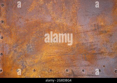 rusty iron texture. Rustic iron plate with rivets. Stock Photo