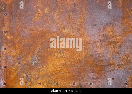 rusty iron texture. Rustic iron plate with rivets. Stock Photo