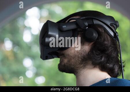 A young man wearing virtual reality headset. Stock Photo