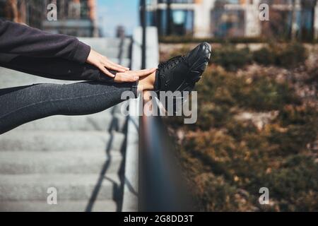 Flexible athlete doing a stretching exercise in a standing position Stock Photo