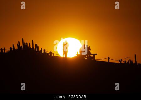 Punta de Lobos, OHiggins, Chile. 17th July, 2021. Tourists gather on the cliffs of Punta de Lobos to watch the sunset. This long weekend some national travel restrictions were lifted in Chile, and thousands of cars left Santiago for regions. (Credit Image: © Matias Basualdo/ZUMA Press Wire) Stock Photo