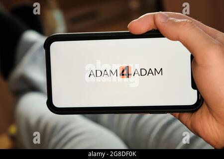 Adam4Adam logo on the smartphone display. Man uses an application for dating and looking for the partner, June 2021, San Francisco, USA Stock Photo