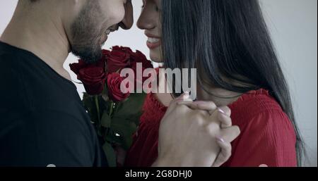 Young Indian couple holding hands and looking at each other with loving facial expression Stock Photo