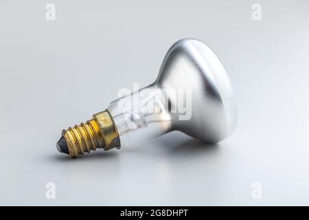 Old light bulb on gray background. Stock Photo