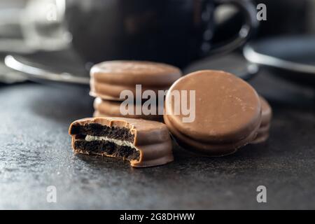 Biscuits with chocolate icing on black table. Stock Photo