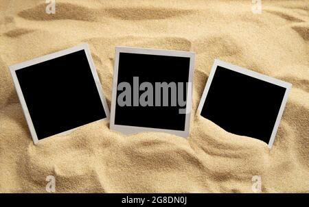 Blank instant images on sand background Stock Photo