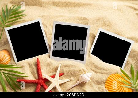 Blank instant images on sand background Stock Photo