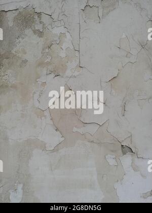 peeled white painting on a brick wall. weathered pattern texture background Stock Photo